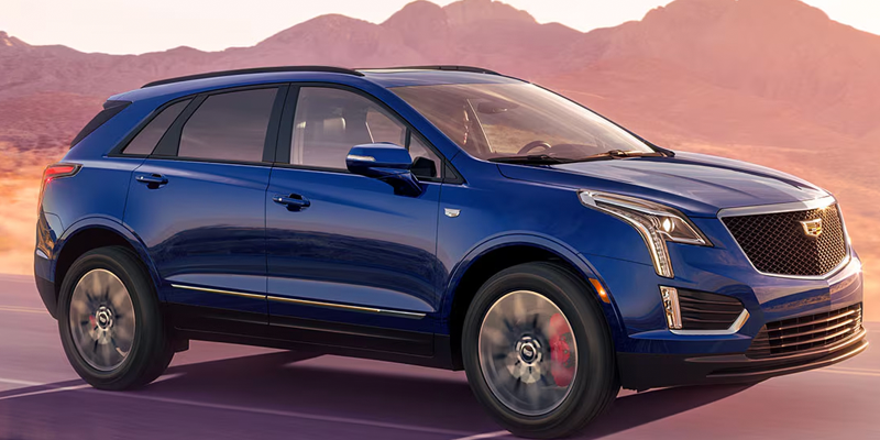 2026 Cadillac XT5 SUV driving through a scenic desert landscape.